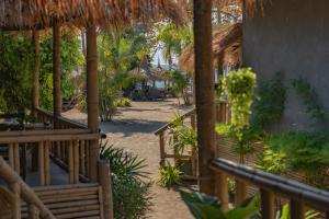 a resort with a pathway with trees and umbrellas at The Lazy Lodge in Ko Lanta