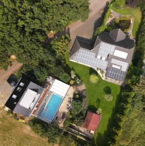 an overhead view of a house with solar panels at Wellness Apartments Sophienhöhe AM TEICH in Mechernich