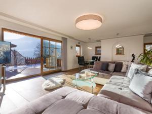 a living room with a couch and a table at Chalet Weinberg Top 1 & Top 2 by Apartment Managers in Kirchberg in Tirol