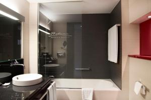a bathroom with a sink, toilet, and bathtub at Pestana Arena Barcelona in Barcelona