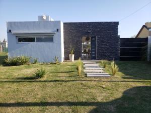 a house with a pathway leading to the front door at DOLCE LUNA in Roldán