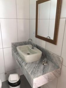 a bathroom with a sink and a mirror at Recanto Filadélfia in Paraty