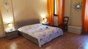 a bedroom with a bed and a table and a chair at Da Simone podere santi Lucia e Pietro in Siena