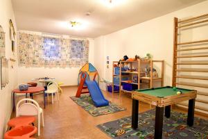 a play room with a pool table and chairs at Nordland Appartements Wohnung Fünen in Wyk auf Föhr