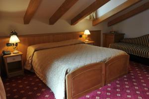 Кровать или кровати в номере Hotel Il Maniero