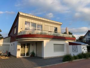 a house with a balcony on top of it at Torsten´s Home in Wunstorf