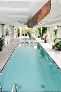 a swimming pool with blue water in a building at Hotel Eldorado at Eldorado Resort in Kelowna
