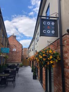 a street with a sign on the side of a building at Rutland Rooms in Oakham