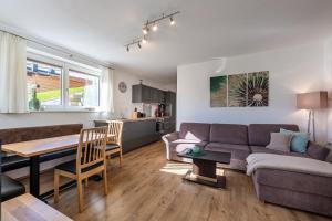 a living room with a couch and a table at Ferienwohnung Alpenglück in Sankt Jakob in Haus