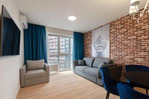 a living room with a couch and a brick wall at 1295 Best loft apartment in Kyiv in Kyiv