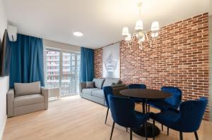 a living room with a brick wall and a table and chairs at 1295 Best loft apartment in Kyiv in Kyiv