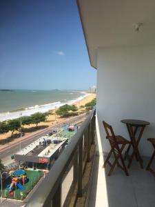 a balcony with a view of a beach and the ocean at SUÍTE ITAPARICA Praia Dourada in Vila Velha