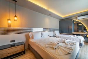 a bedroom with two beds with white pillows at S3 Seahorse Beach Club in Oludeniz