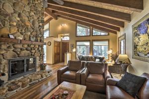 a living room with a stone fireplace and leather chairs at Zephyr Cove Escape with Deck - Steps to Beach! in Zephyr Cove