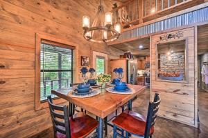 a dining room with a wooden table and chairs at Luxe Cabin with Tesla Charging Station, 3 Mi to Lake in Stephens Gap