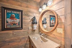 a bathroom with a sink and a mirror at Luxe Broken Bow Cabin with Tesla Charging Station in Stephens Gap +26 photos