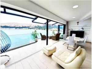 a living room with a view of the water at Apartments Palada 1 in Baška