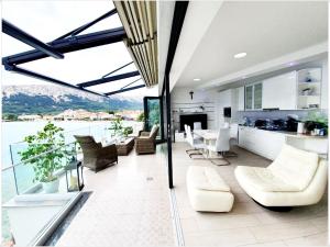 a living room and kitchen with a view of the water at Apartments Palada 1 in Baška