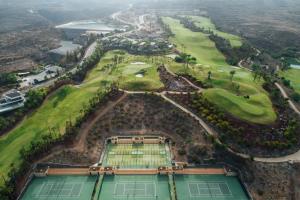 an aerial view of a golf course with two tennis courts at Los Jardines de Abama Suites in Guía de Isora