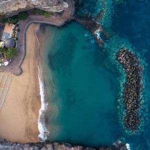 an aerial view of a beach and the ocean at Los Jardines de Abama Suites in Guía de Isora