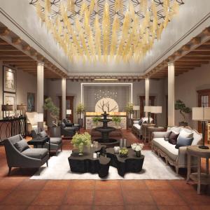 a lobby with couches and tables and a chandelier at Dos Patios Querétaro Curamoria Collection in Querétaro