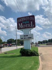 un cartello per un motel sul ciglio di una strada di Coachman's Inn Motel a Wynne