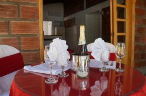 a bottle of wine sitting on a table with wine glasses at Hostería Fundadores in Santa Fe de Antioquia