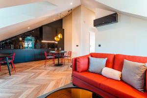 a living room with a red couch and a table at FLH Viola Market Flats with Terrace in Funchal