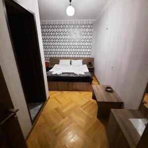 A bed or beds in a room at GIO-NIKA