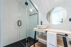 a bathroom with a sink and a glass shower at FLH Viola Market Flats with Terrace in Funchal