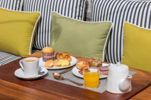 a tray of breakfast foods and drinks on a table at Pur Oporto Boutique Hotel by actahotels in Porto