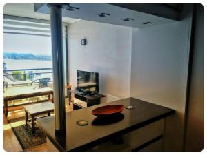 a kitchen with a table with a bowl on a counter at Vista al río Calle - Calle in Valdivia