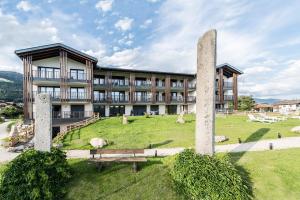 a large building with a monument in front of it at Chalet Kristall - Dolomites Garden Chalet in Falzes