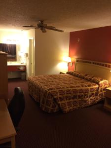 A bed or beds in a room at Value Inn & Suites