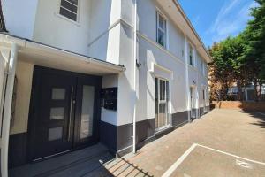 a white building with a door on the side of it at Town Centre 1 Bed, Close to the Beach with Parking in Bournemouth