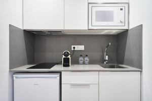 Kuchyň nebo kuchyňský kout v ubytování Aparthotel Augusta