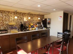 a kitchen with a table and a counter top at Red Roof Inn Portsmouth - Wheelersburg in Wheelersburg