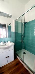 a bathroom with a sink and a glass shower at La Casa di Andreina in Mondello