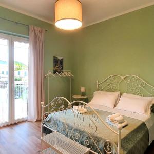 a bedroom with a bed with a green wall at La Casa di Andreina in Mondello