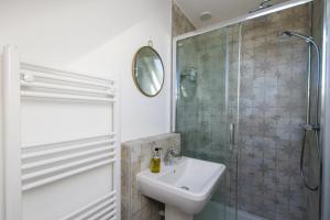 a white bathroom with a sink and a shower at Bright & Beautiful Studio Flat in Bristol! in Bristol