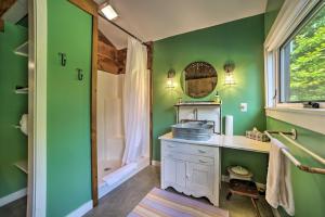 a bathroom with green walls and a sink and a shower at Historic Catskills Home, Near Willowemoc Creek! in Livingston Manor +47 photos