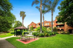 a park with a picnic table and a gazebo at Comfort Apartments Royal Gardens in Melbourne