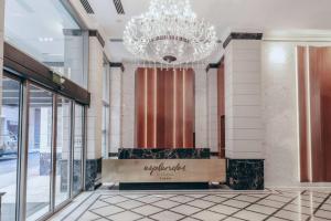 a lobby with a chandelier in a building at Esplendor by Wyndham Buenos Aires Tango in Buenos Aires