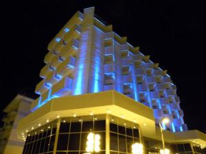 a building with blue lights on top of it at Hotel Diplomat Palace in Rimini
