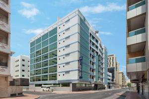 
a large building with a lot of windows at Howard Johnson Plaza by Wyndham Dubai Deira in Dubai
