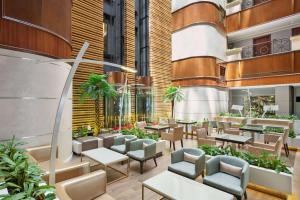 un restaurante con mesas y sillas en un edificio en Howard Johnson Plaza by Wyndham Dubai Deira, en Dubái