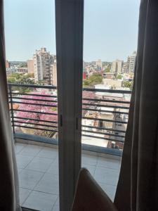 a room with a view of a city from a window at Nuez de la Isla "Centro Apart"-MICROCENTRO- Balcón al frente 8vo in Paraná