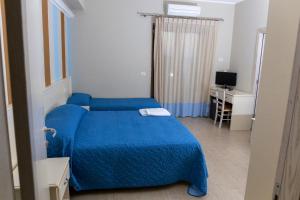 Ένα ή περισσότερα κρεβάτια σε δωμάτιο στο Hotel Al Rustico