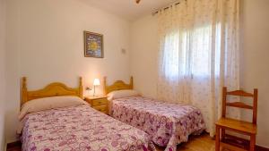 A bed or beds in a room at Casa Tejo Sedella by Ruralidays