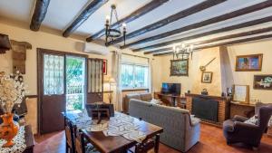 a living room with a table and chairs and a fireplace at Villa Andrea Cortes de la Frontera by Ruralidays in Cortes de la Frontera